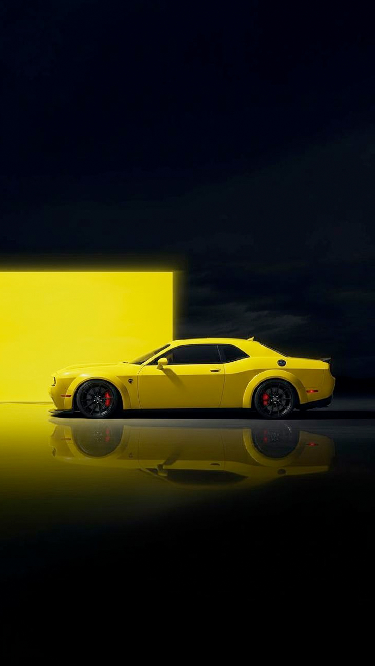 A sleek yellow sports car with black wheels and red brake calipers is captured in a striking side profile.