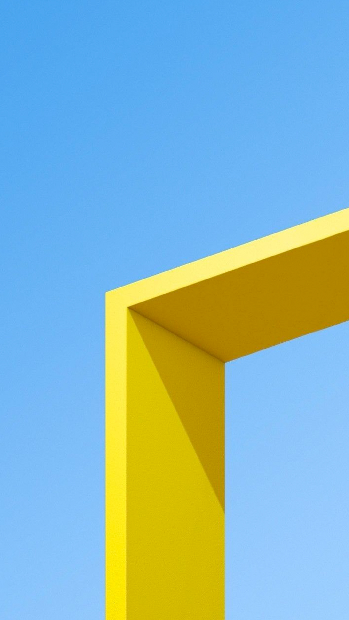 A yellow frame stands out against a brilliant blue sky.