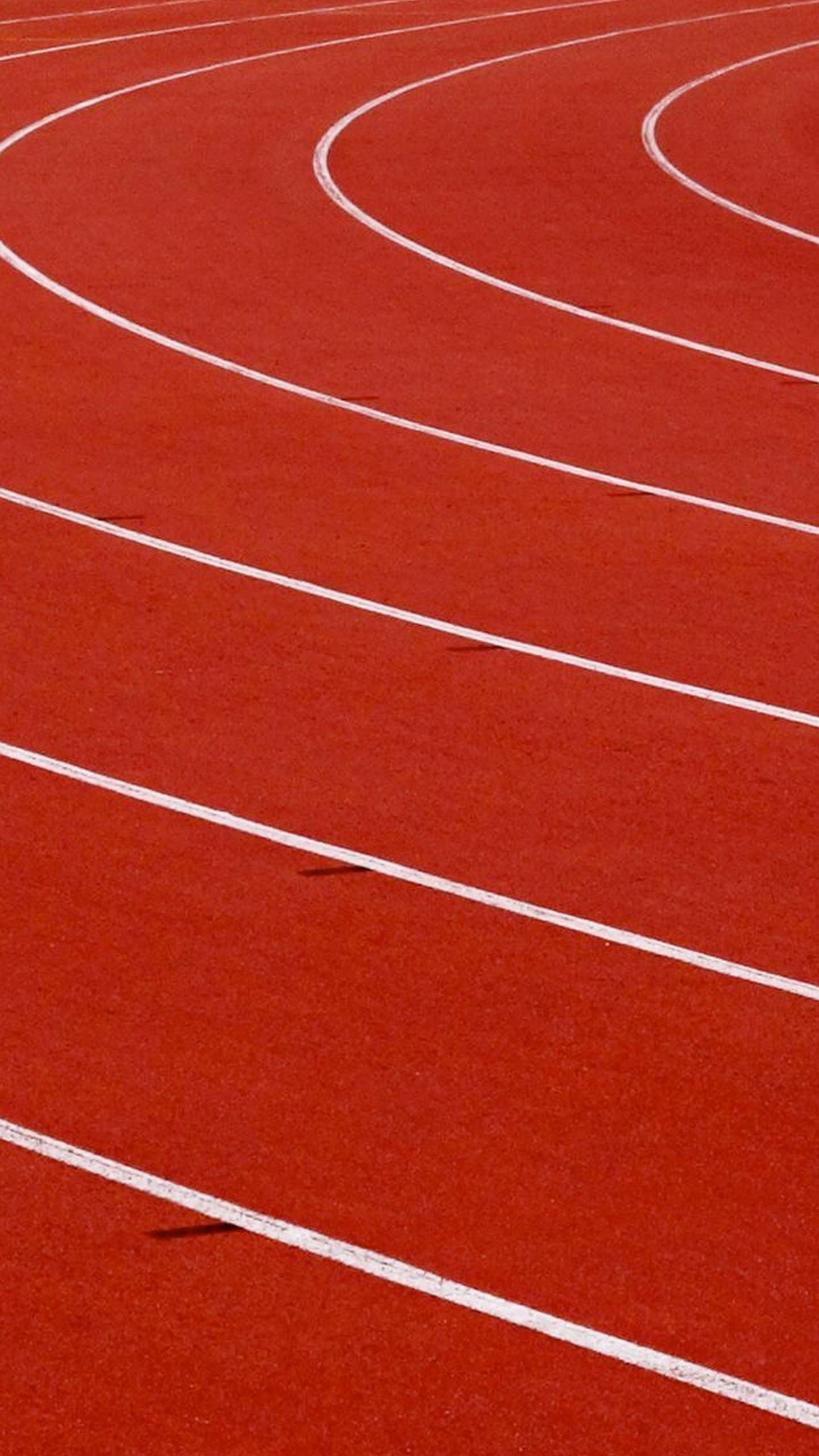 Red running track with white lines.