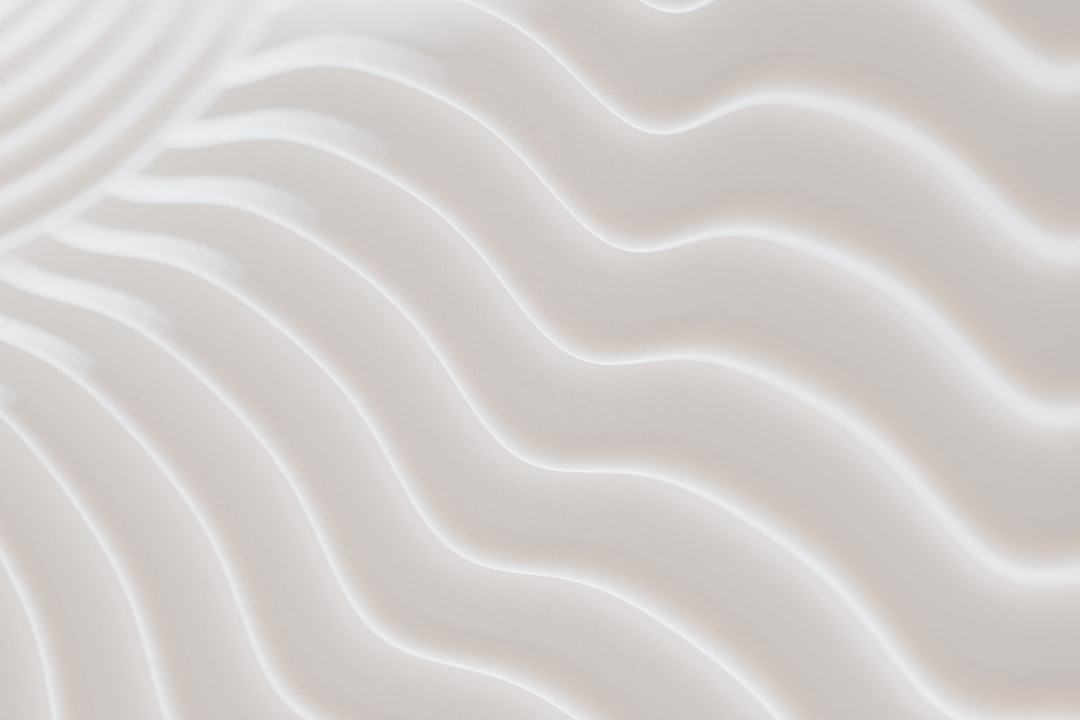 Soft, white sand dunes stretch out in wavy patterns.