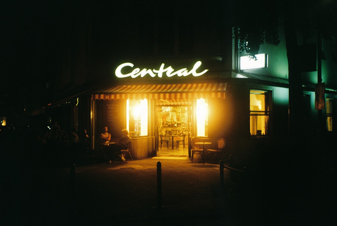 A storefront with a sign reading "Central" is illuminated at night.