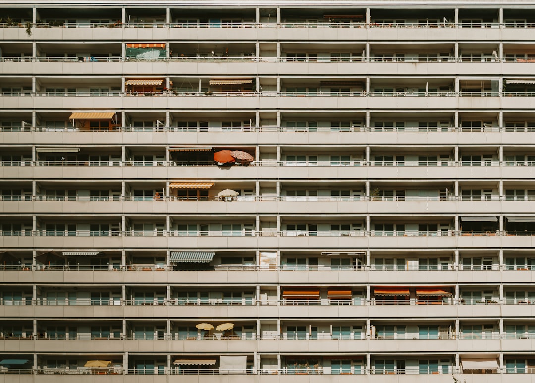 A large building with multiple balconies and awnings is visible.