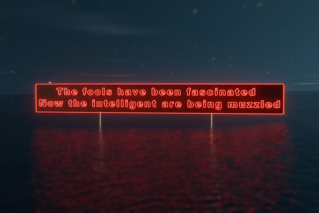 Red neon sign on a dark background with a subtle reflection.