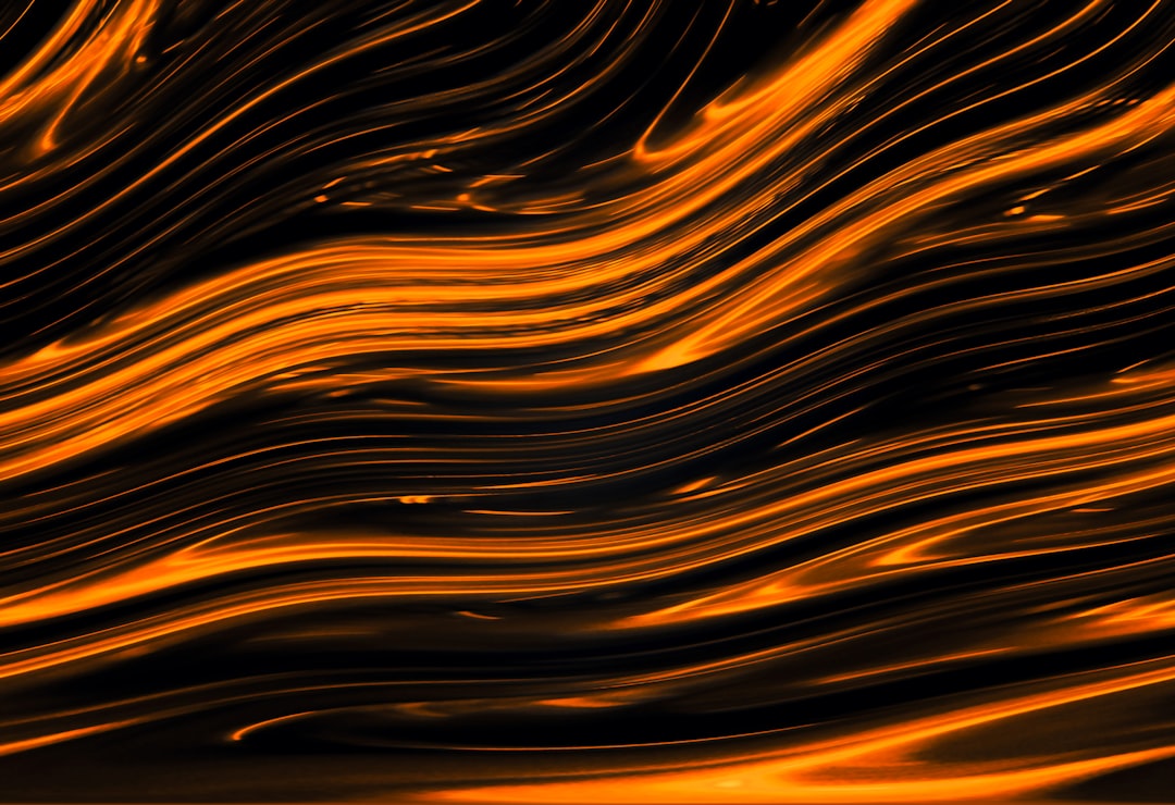 Vibrant orange lines radiate against a black background.