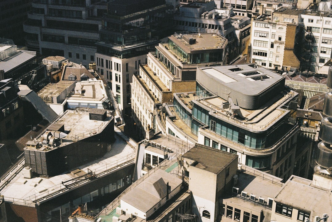 A bird's-eye view of a cityscape, featuring a mix of buildings and rooftops.
