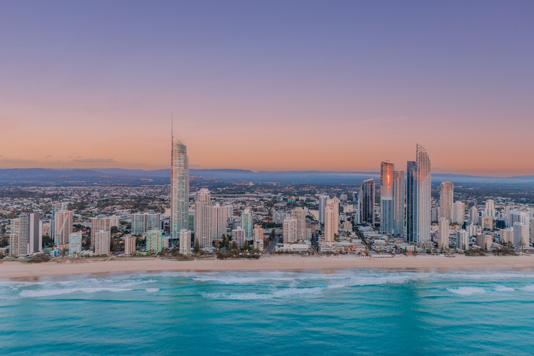 A vibrant beachside cityscape at dusk, with a stunning array of skyscrapers and a picturesque shoreline.