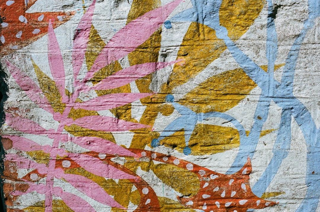 A vibrant mural adorns the wall, featuring a kaleidoscope of colors and patterns, including pink, yellow, blue, and orange.