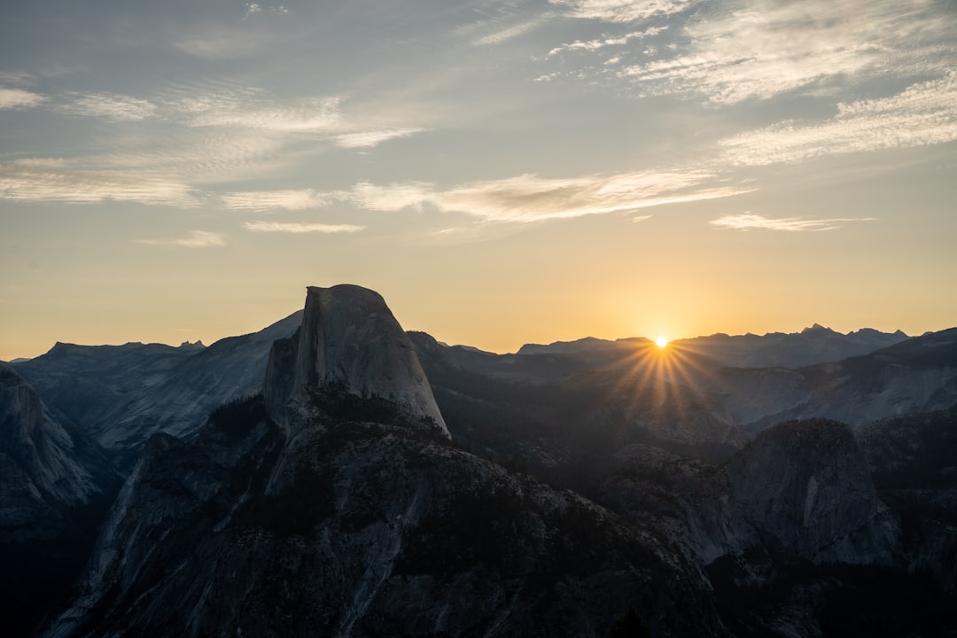 A majestic mountain range is bathed in the warm glow of sunset light.