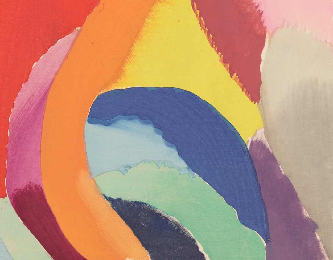A vibrant, multicolored abstract painting dominates the frame, with bold brushstrokes and a kaleidoscope of hues.