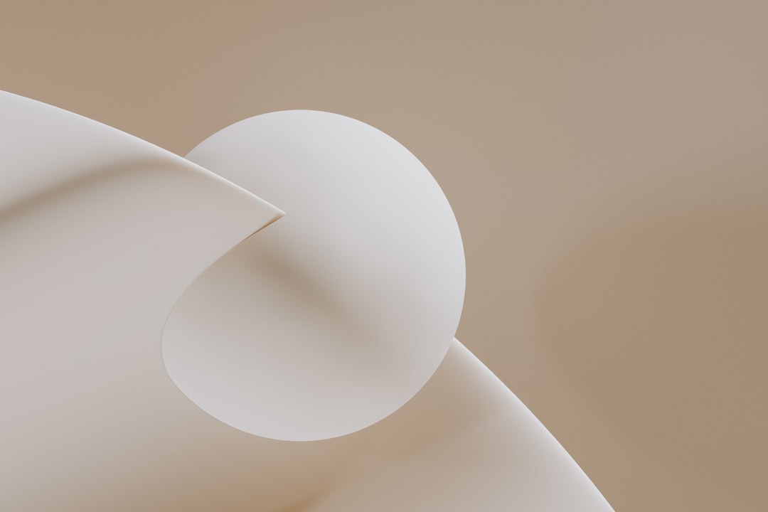 Soft, curved shapes in a light beige and white color scheme.