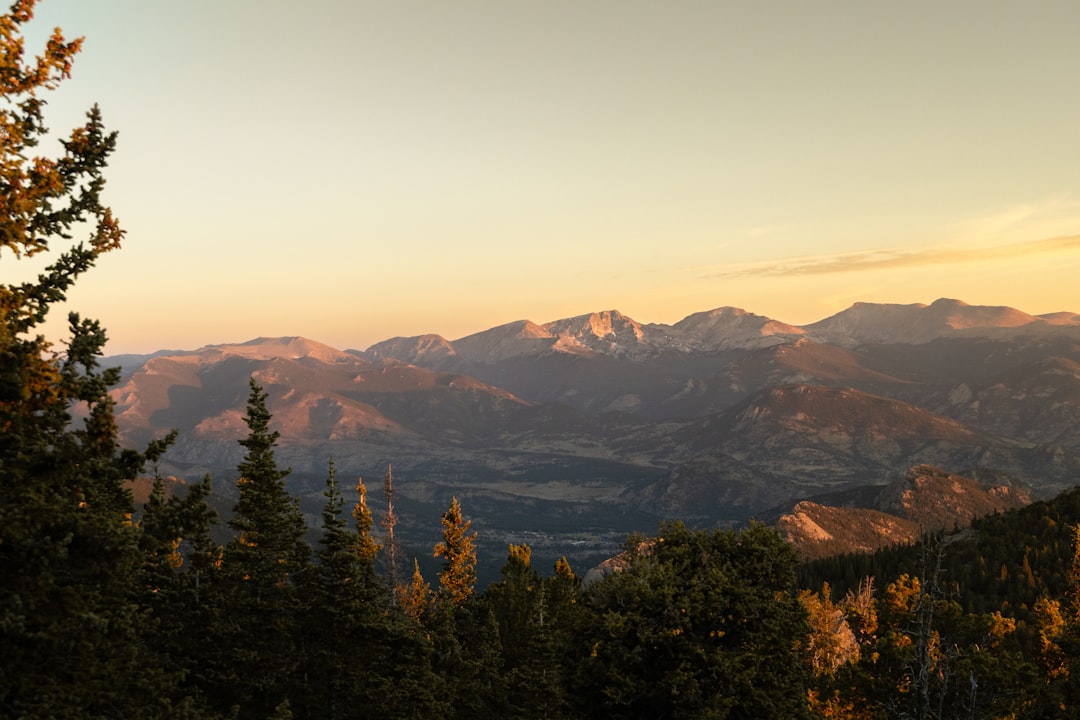 A mountain range bathed in warm sunlight.