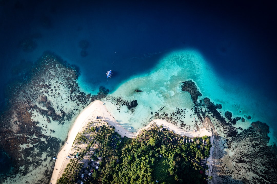 A serene tropical island with lush greenery, a pristine white beach, and crystal-clear turquoise waters.