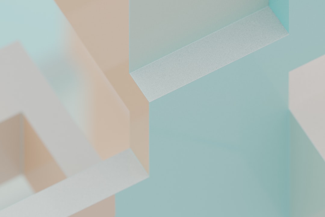 Soft pastel colors intersect and overlap in a geometric pattern.