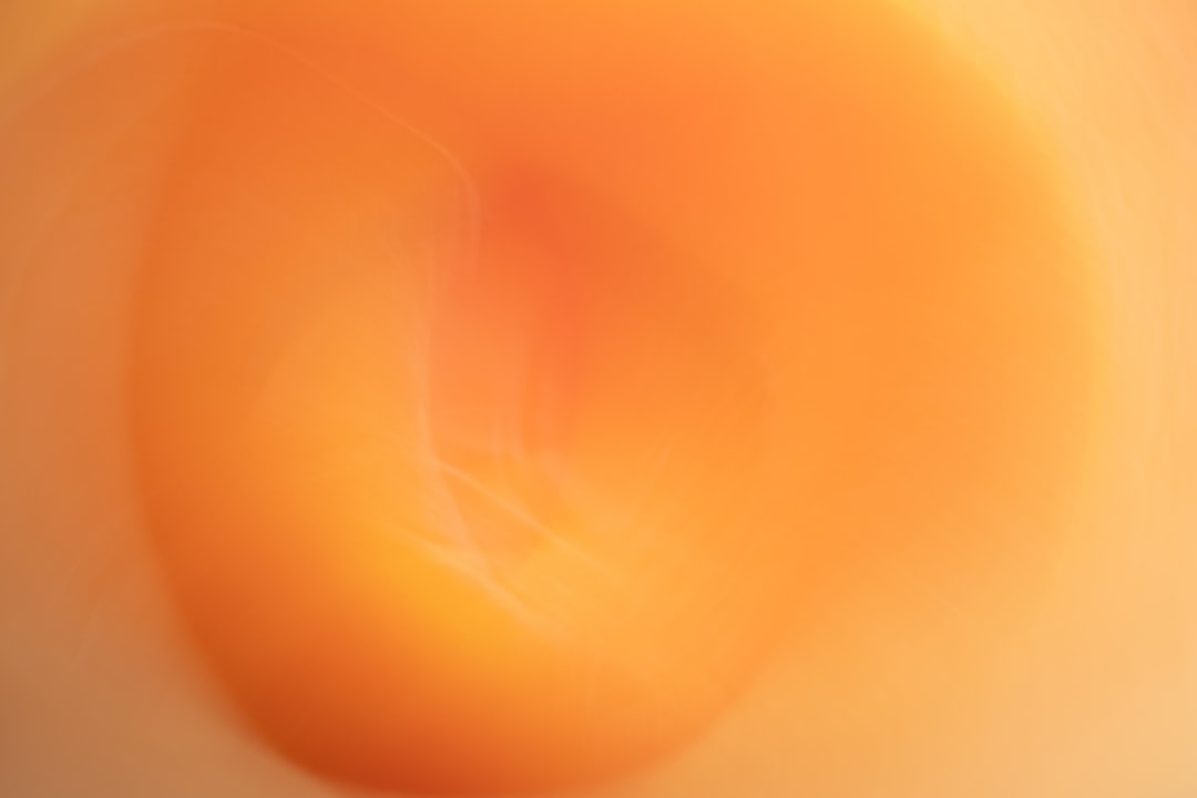 A vibrant orange circle dominates the center of the image, with a subtle gradient effect that adds depth and dimensionality.