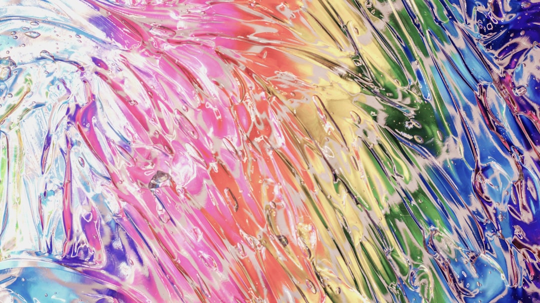 A vibrant, abstract rainbow-colored swirl of colors.