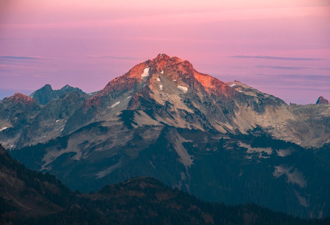 Snow-capped peaks glisten in the fading light.