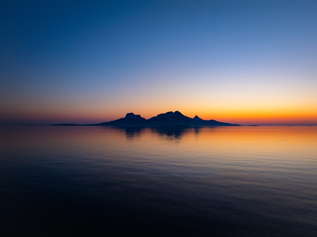 A majestic mountain range is set ablaze by the vibrant hues of a breathtaking sunset.