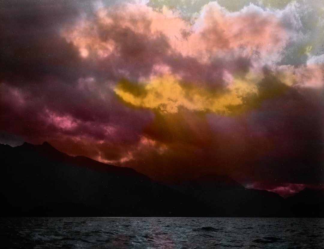 A serene mountain range bathed in the warm glow of sunset.