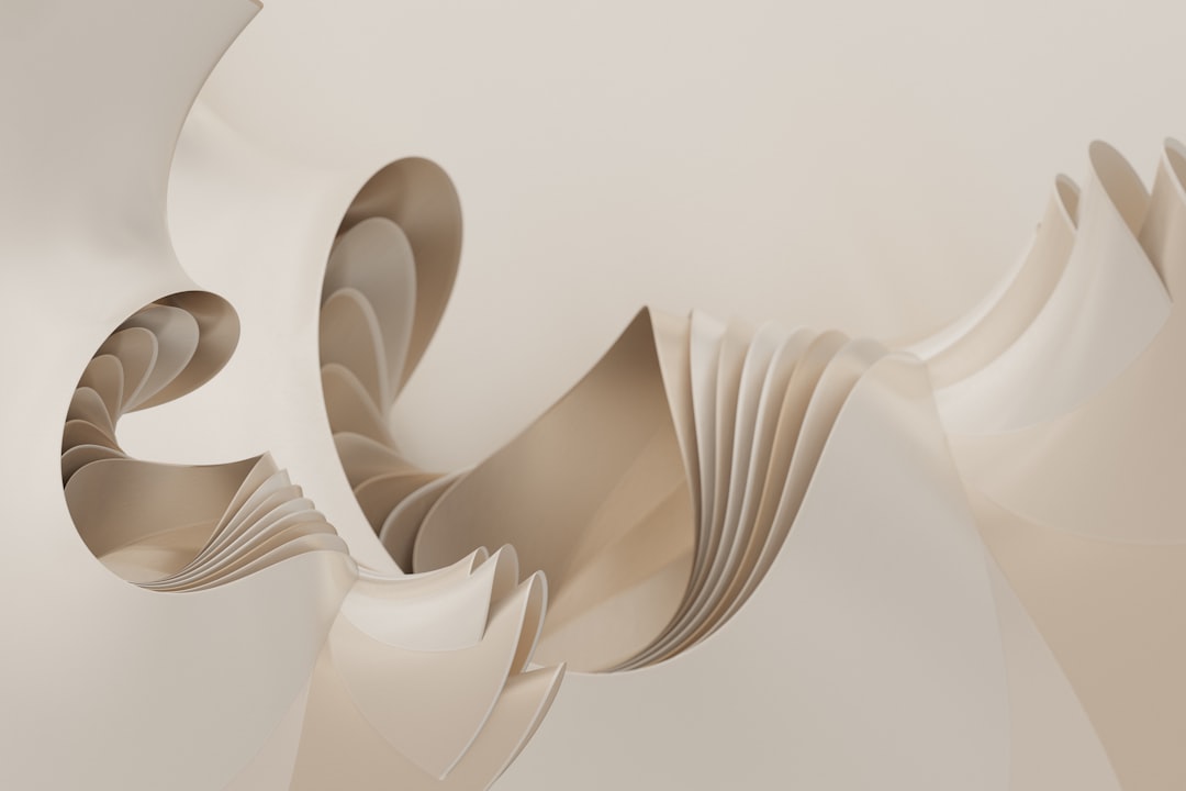 Layers of white and tan paper unfold in a flowing, organic shape.