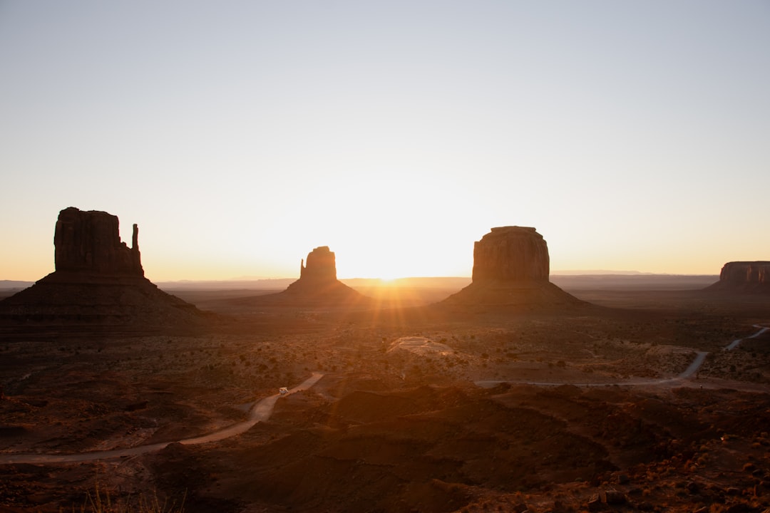 Red rock formations stand tall under a vibrant sunset sky.