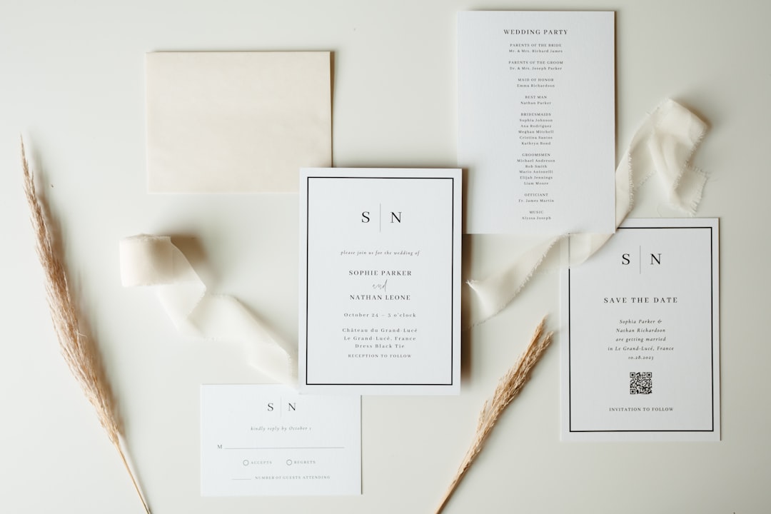 A wedding invitation set, featuring a cream-colored background and elegant design elements.