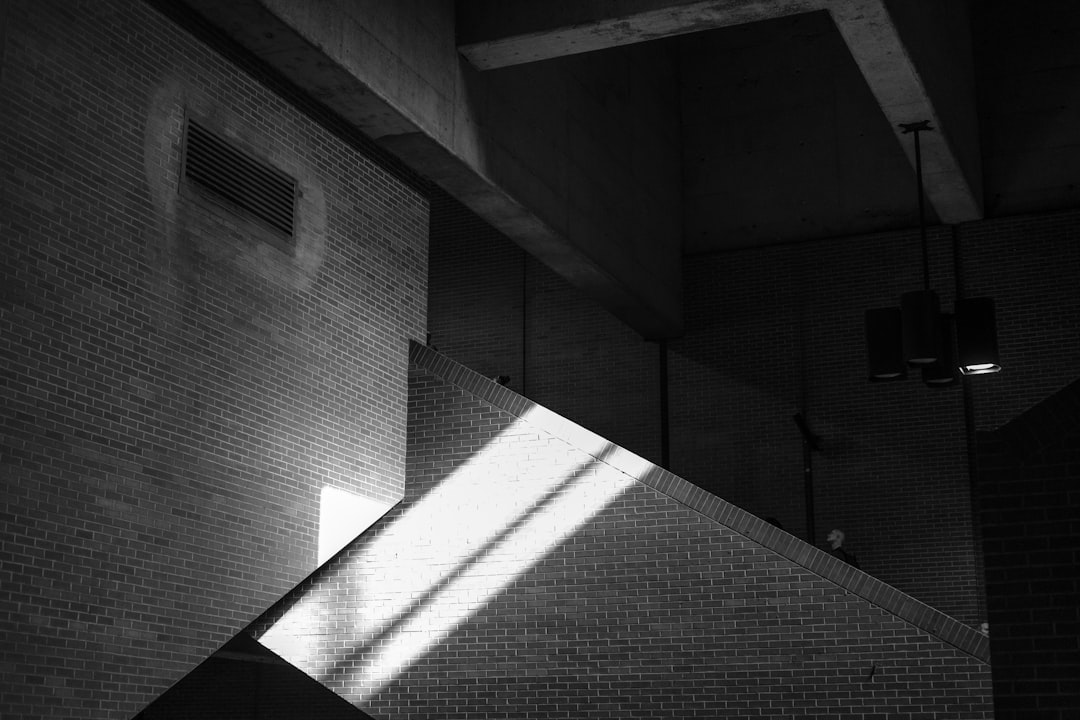 A diagonal beam of sunlight illuminates a brick staircase.