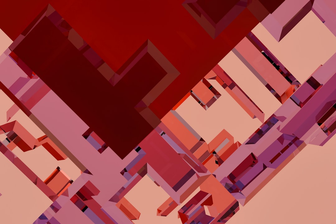 A vibrant red and pink 3D graphic dominates the scene, featuring a complex arrangement of interlocking shapes.