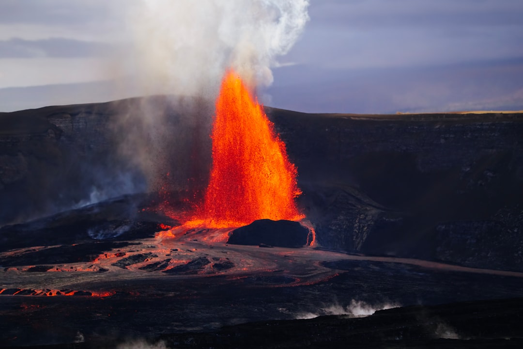 A fiery volcano erupts, spewing molten lava and smoke into the air.