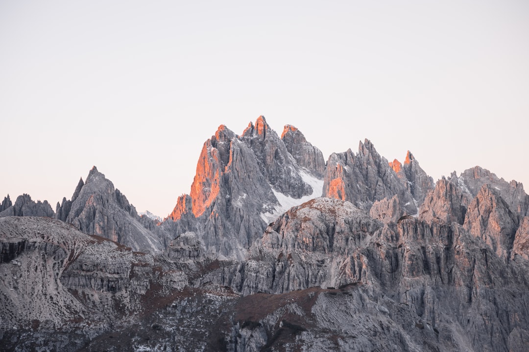 Grey mountains with a touch of orange from the setting sun.