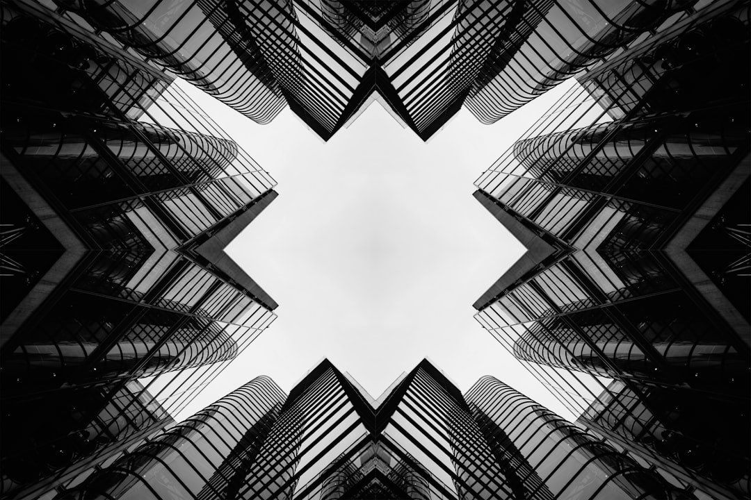 Black skyscrapers form a symmetrical pattern around a central white space.