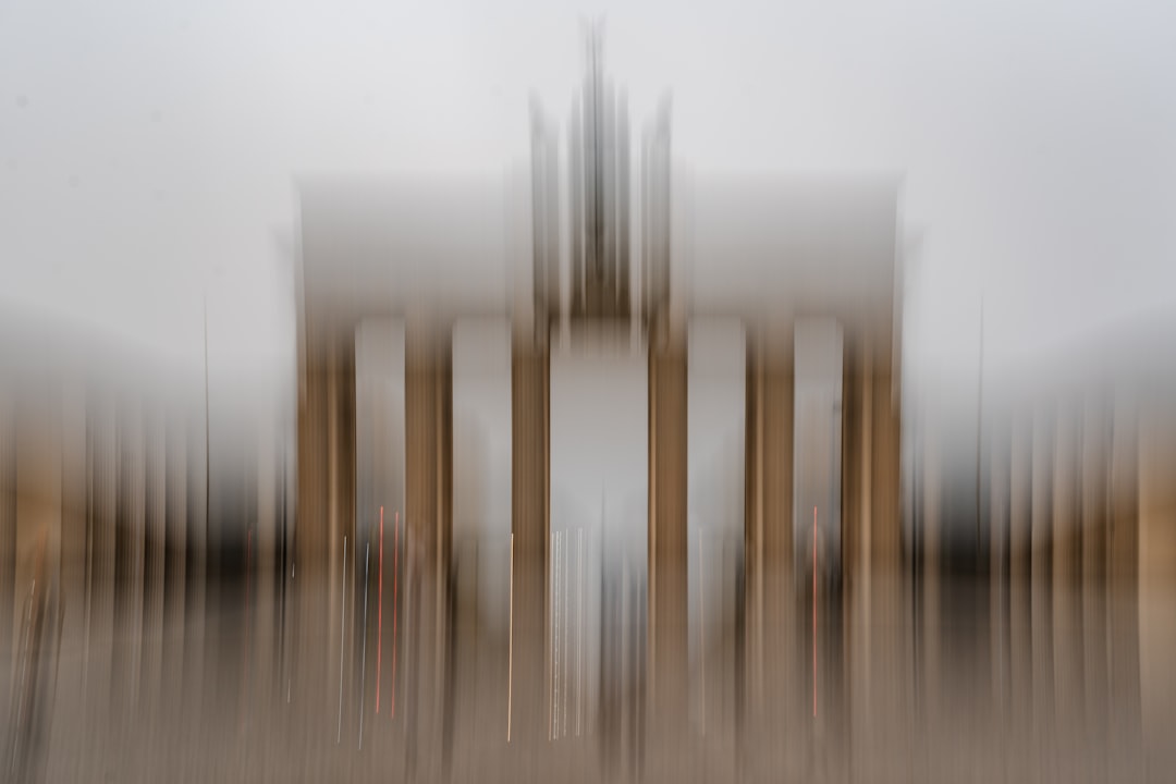 Red lines appear on a blurred background of brown and white vertical lines.