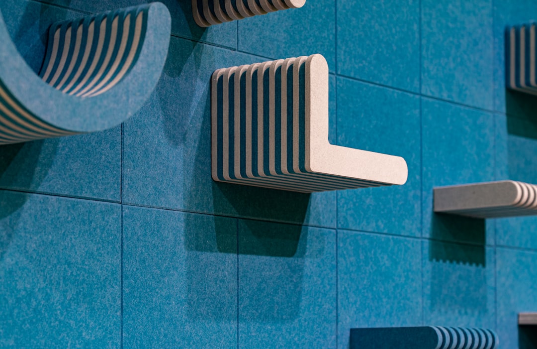 Blue wall with white shelves.