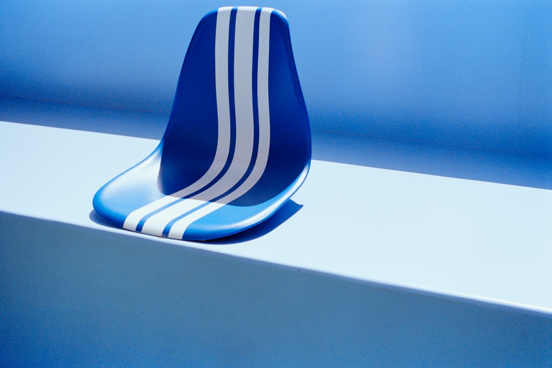 A blue and white striped object sits atop a light blue surface.