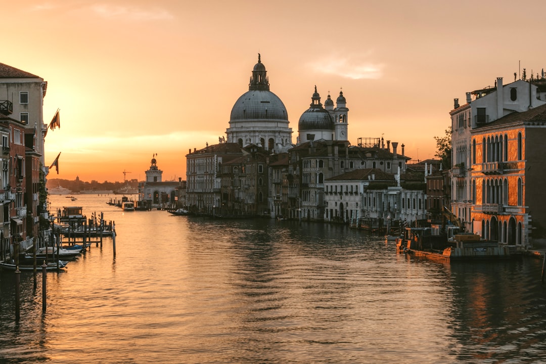 Venice's Grand Canal is bathed in golden light at sunset.