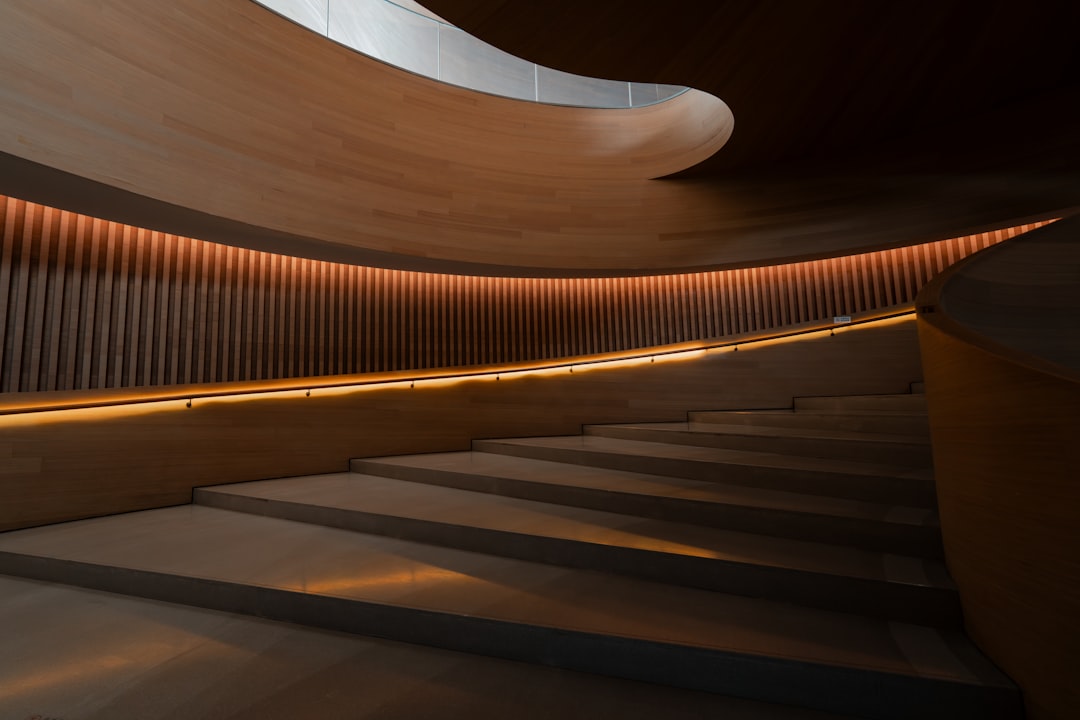 A modern staircase with wooden walls and lighting, creating a sleek and contemporary atmosphere.