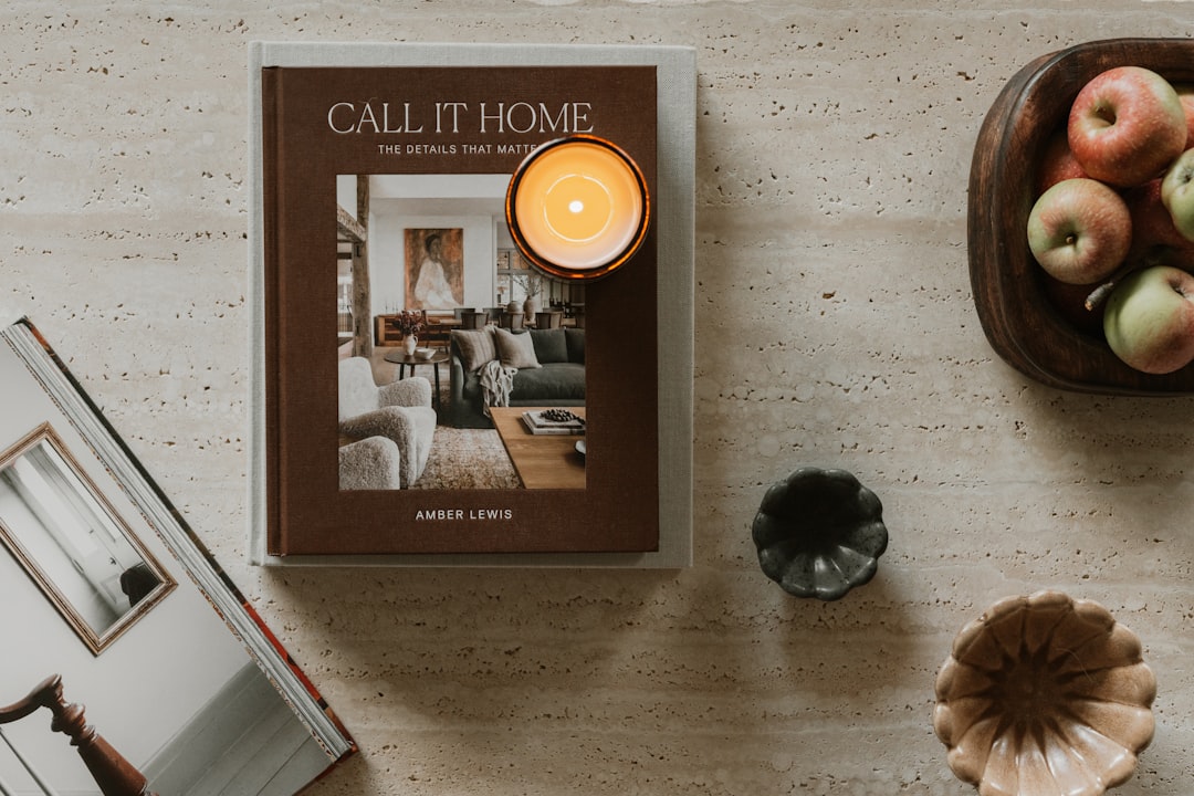 A book titled "Call It Home" sits on a table, surrounded by various decorative items.