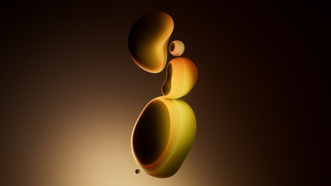 Soft, golden shapes float in a dark, gradient background.