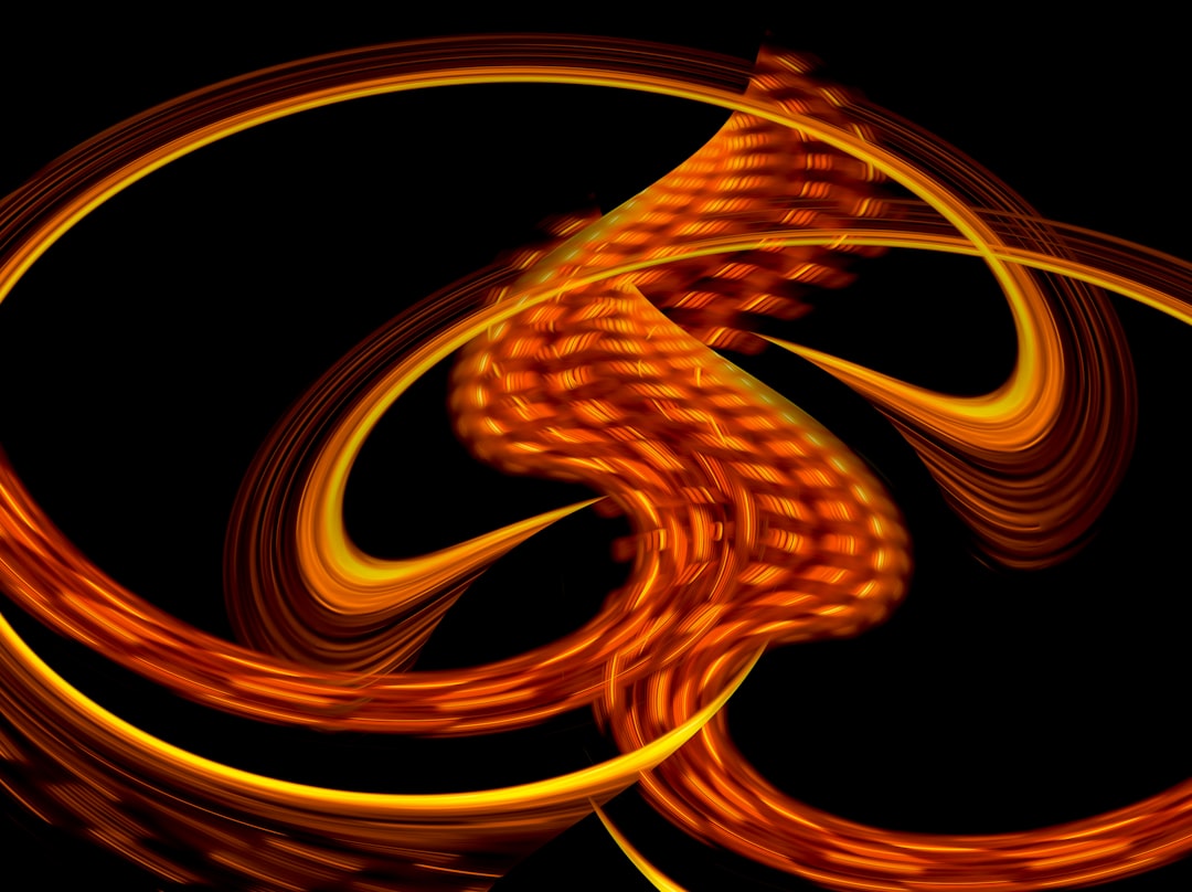A vibrant orange and yellow spiral pattern against a black background.
