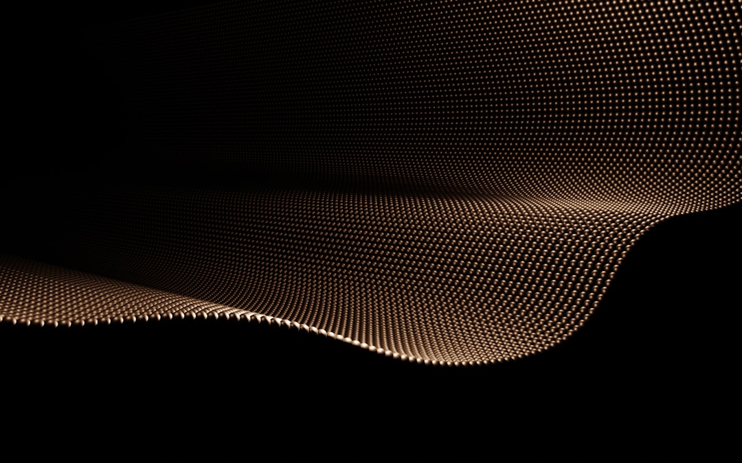 A golden wave-like structure is set against a black background, evoking a sense of movement and energy.