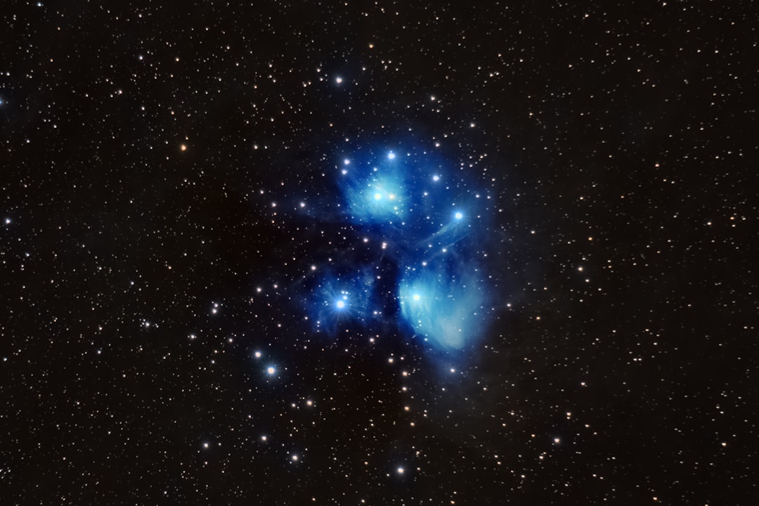 Bright blue stars shine against a dark, star-filled background.