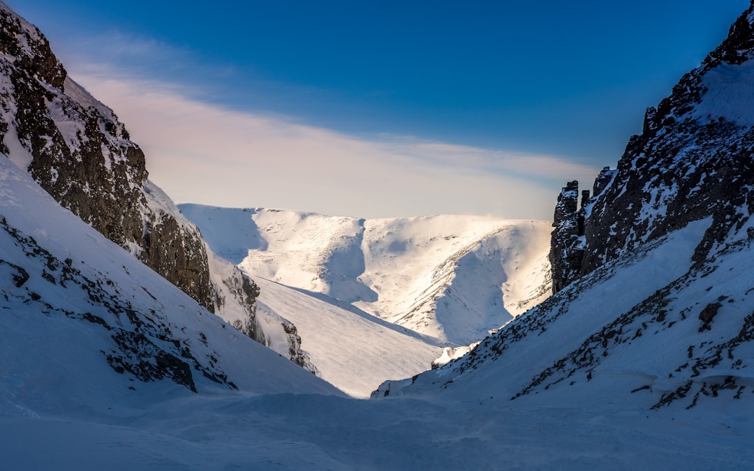 Snow-covered mountains under a blue sky.