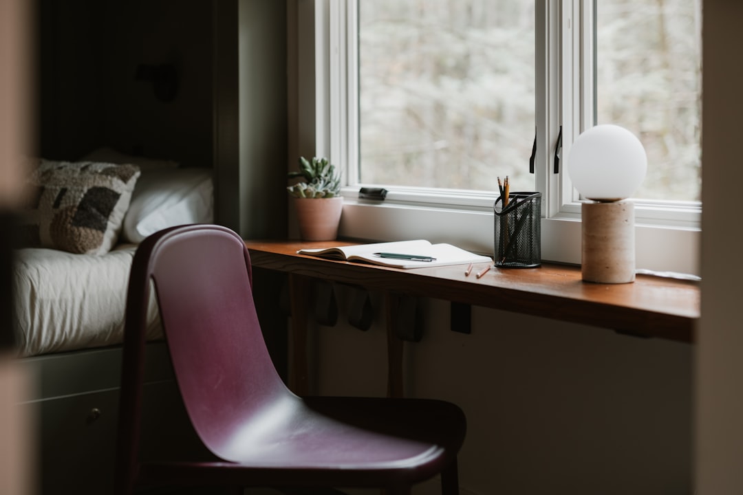 A serene room with a window seat, a desk, and a chair, bathed in natural light.