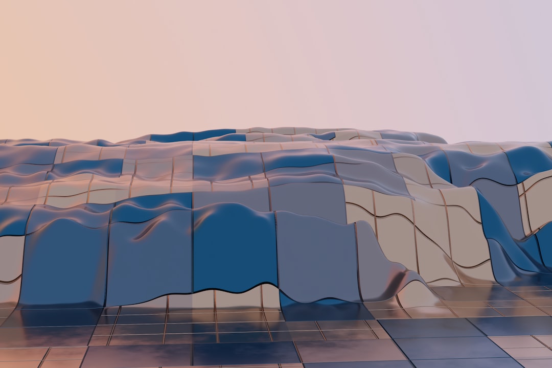 Soft, blue and pink hillsides undulate under a pale sky.