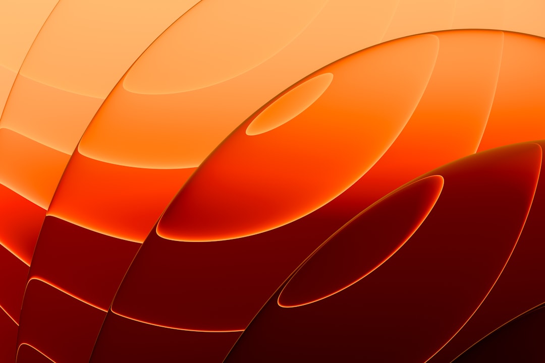 Sunlight filters through orange and red shapes, casting a warm glow.
