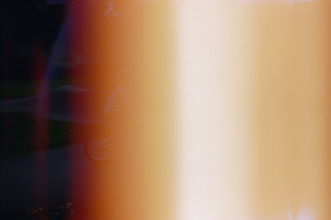 A vibrant gradient of colors, including black, red, orange, and yellow, creates a striking visual effect.