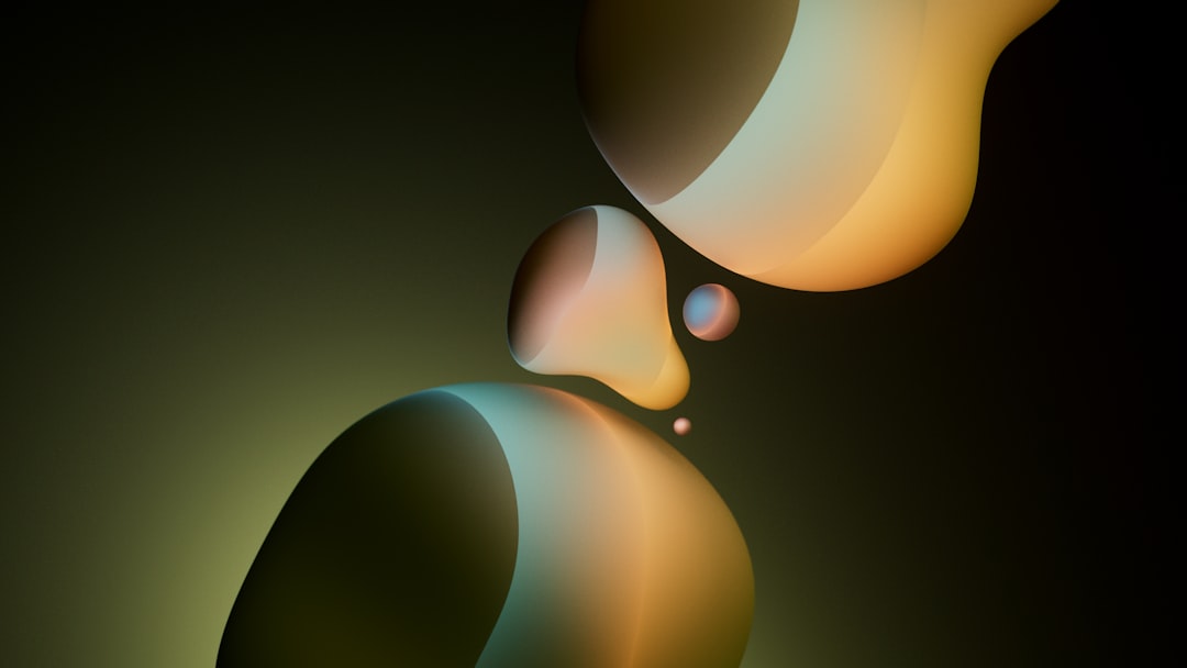 Golden, teardrop-shaped objects with smooth, curved surfaces float in space against a dark background.